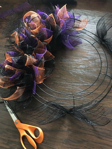 Use chenille stems/sticks or pipe cleaners to attach mesh to the wreath form. DIY Mesh Dollar Tree Halloween Wreath | Dollar tree ...