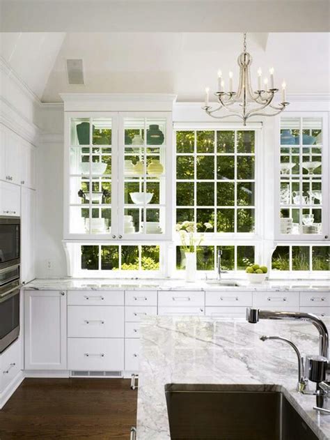 Traditionally, kitchen cabinets are mounted on walls. Double sided glass cabinet to exterior acts like window to ...