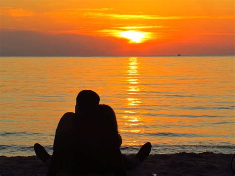 Download Couple Sunset Cuddling On Beach Picture