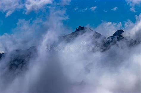 Heavy Clouds And Fog Hide Most Of Mountain Range Stock Image Image Of