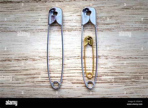 Safety Pins On Wooden Background As Announcing Pregnancy Stock Photo