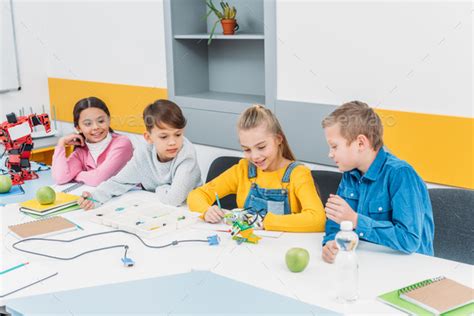 Happy Children Working Together On Stem Project In Classrom Stock Photo