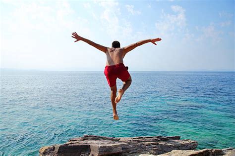 Man Cliff Jumping Stock Photos Pictures And Royalty Free Images Istock