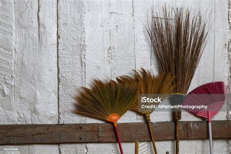 Old Brooms Leaning Against A Wall Stock Photo Download Image Now