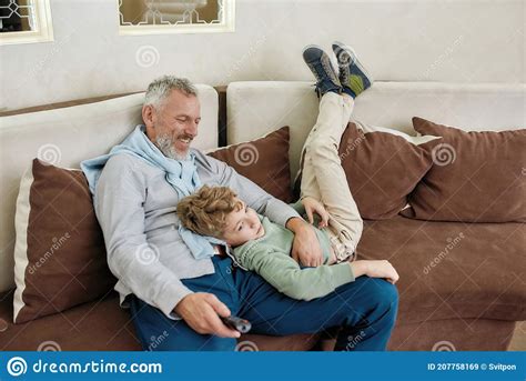 Loving Grandpa Portrait Of A Happy Grandfather And Excited Grandson Embracing Having Fun And