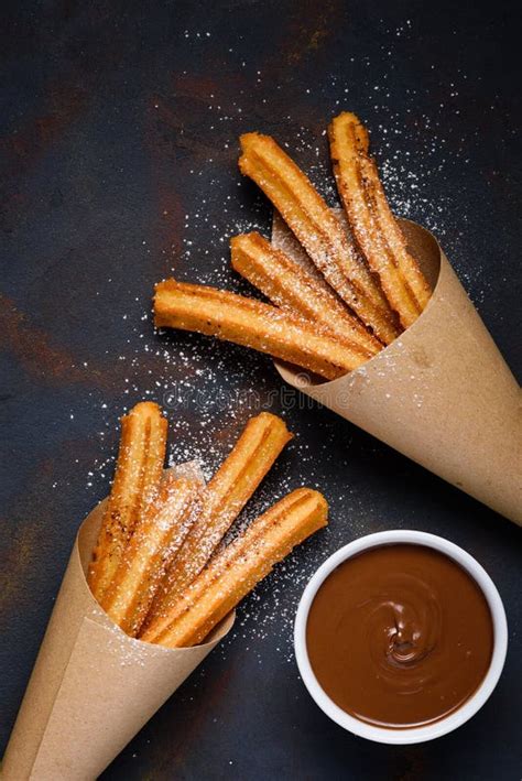 Traditional Churros Sticks In Paper Bag With Sugar Powder Cinnamon And