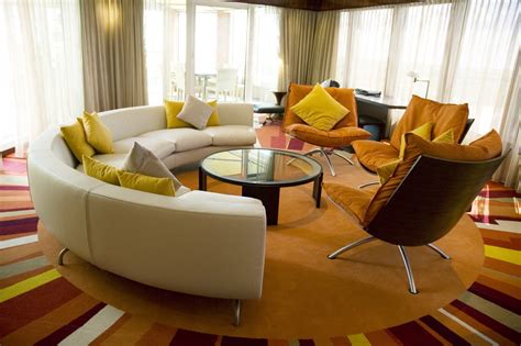 Circular Living Room Features Bright Multi Colored Sun Pattern