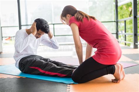 Woman Trainer Help Sportsman Sit Ups In Gym Stock Photo Image Of