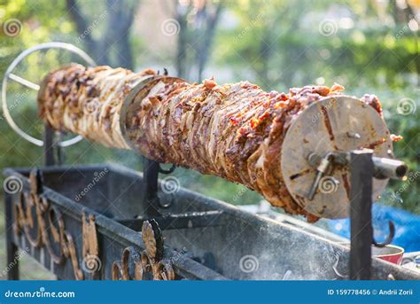 A Rotating Spit Roast Of Meat Over Hot Coals Grill Meat Dish Roasted