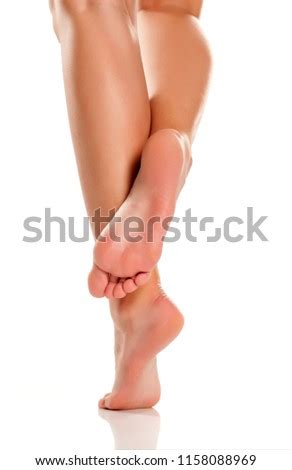 PRETTY FEMALE LEGS AND BARE FEET ON WHITE BACKGROUND Stock Photos And
