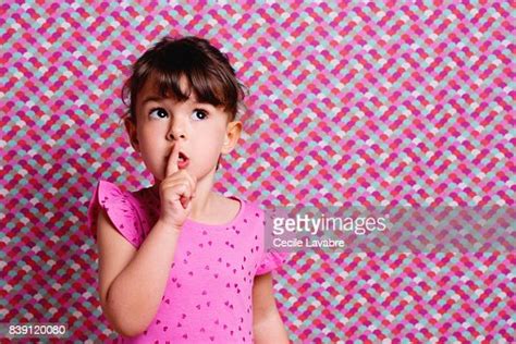 Girl With Finger By Mouth Portrait Photo Getty Images