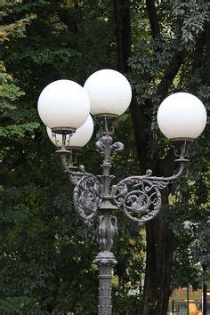 This lamp post brings multifunctional style to your outdoor decor. 4 arm 5 light cast aluminum street lamp post with round ...