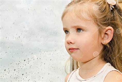 Little Girl Looking Out The Window On A Rainy Day Stock Image Image