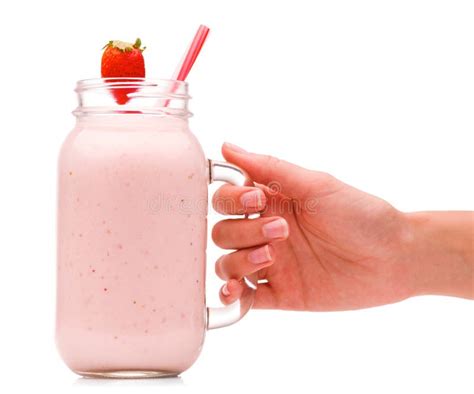 A Girl Is Holding A Jar With Strawberry Smoothies And With A Juicy Strawberry Berry Isolated