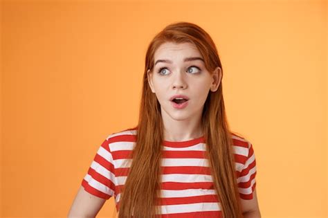 free photo close up of surprised and excited redhead girl hear amazing news staring at camera