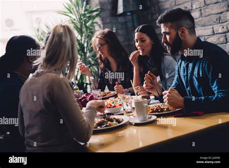 Group Of Happy Business People Eating Together In Restaurant Stock