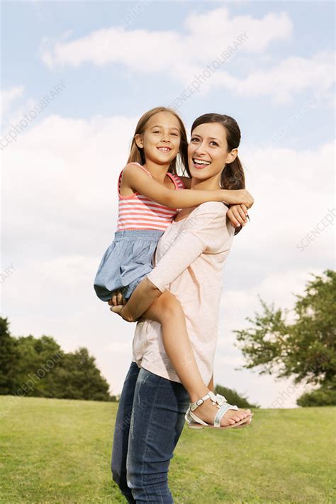 Mother Carrying Daughter Stock Image F007 9456 Science Photo Library