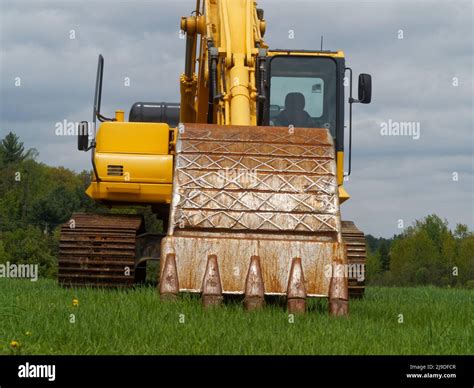 Excavator Parked On Grass Stock Photo Alamy