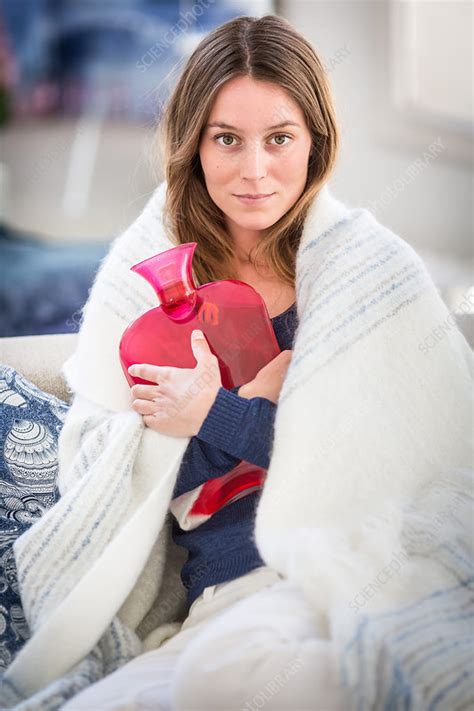 Woman Holding A Hot Water Bottle Stock Image C035 0899 Science Photo Library