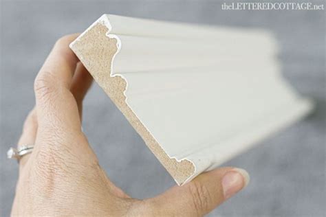 A Hand Holding A Piece Of White Paper