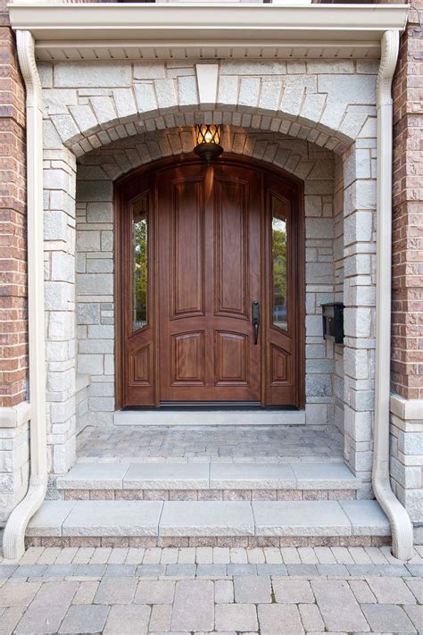 Medium Brown Arched Stained Front Door With Glass Sidelights Brick