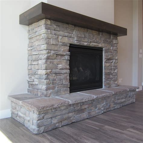 Alder Wood Mantel With Raised Stone Wrap Around Hearth And Stone