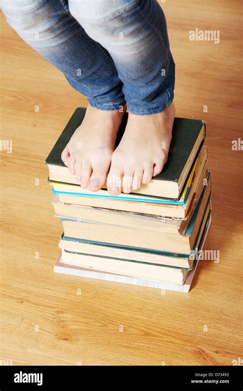 Girl Standing On Pile Of Books Stock Photo Alamy