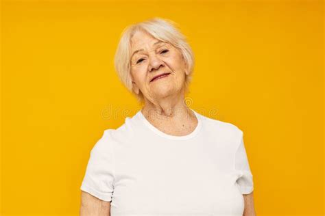 Portrait Of An Old Friendly Woman Posing Face Grimace Joy Yellow Background Stock Image Image