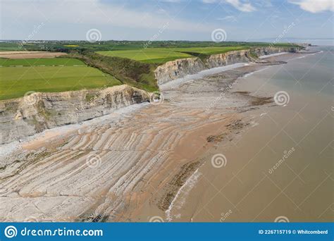 Aerial View Of Sea Cliffs Rock Formations And A Sandy Beach