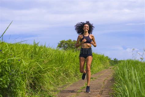 Happy Female Runner Training On Countryside Road Young Attractive And