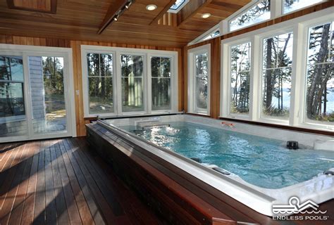 An Indoor Jacuzzi Is Shown In The Middle Of A Wood Floored Room