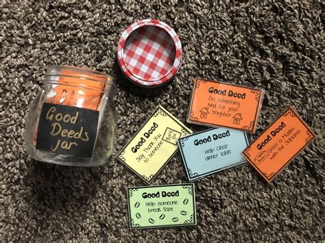 A Jar Filled With Orange And Yellow Labels Sitting On Top Of A Carpet