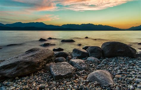 375x667 Resolution Brown Rocks Bear Body Of Water During Sunset Hd