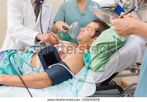 Doctor Nurses Examining Critical Male Patient Stock Photo Edit Now