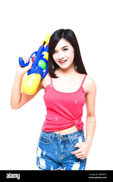Cheerful Young Woman With Squirt Gun Against White Background Stock