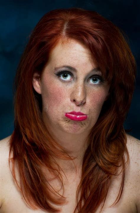 Young Casual Red Haired Female Portrait Pulling A Face Stock Image