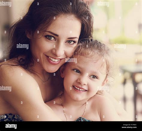 Happy Beautiful Mother Cuddling Her Small Daughter With Smile In Cafe Closeup Vintage Portrait