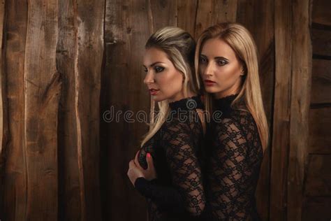 Lesbian Lovers Foreplay At Wall With Handcuffs And Whip Stock Image