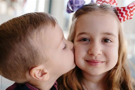 Big Sister Receiving A Kiss From Her Little Brother By Stocksy Contributor Jakob Lagerstedt