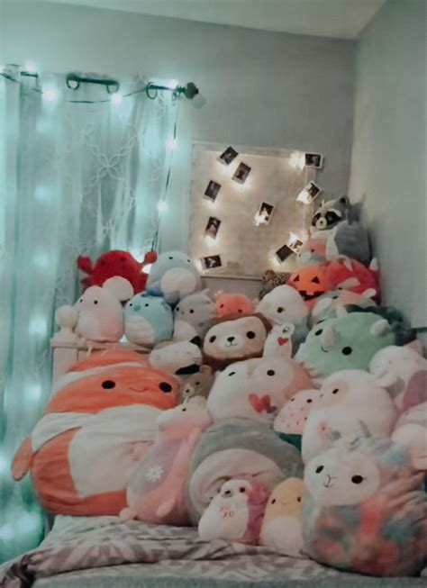 A Bed With Lots Of Stuffed Animals On Top Of It And Lights Behind The