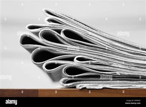 Folded Newspapers On Brown Wooden Table Stock Photo Alamy