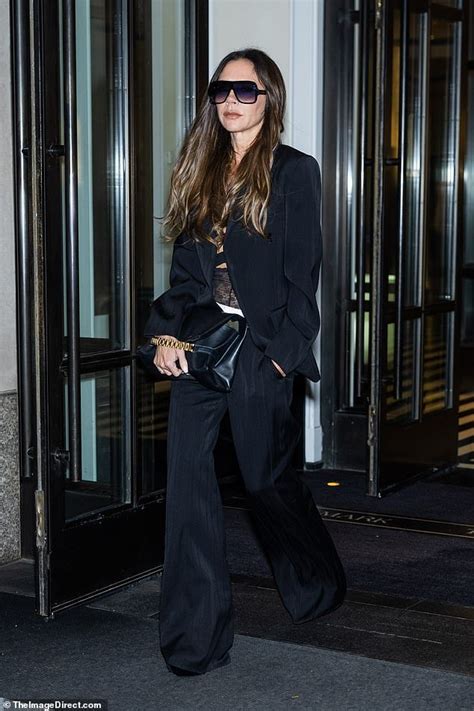 Victoria Beckham Cuts A Chic Figure In A Sleek Black Satin Trouser Suit