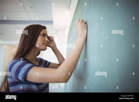 Schoolgirl Pretending To Be A Teacher In Classroom At School Stock