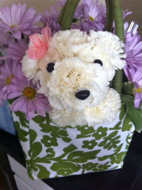 A Stuffed Animal In A Bag With Flowers