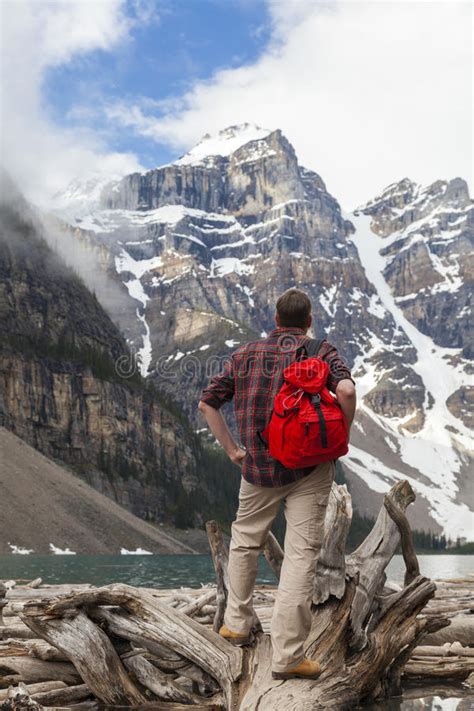 Hiking Man Looking At Moraine Lake And Rocky Mountains Stock Photo