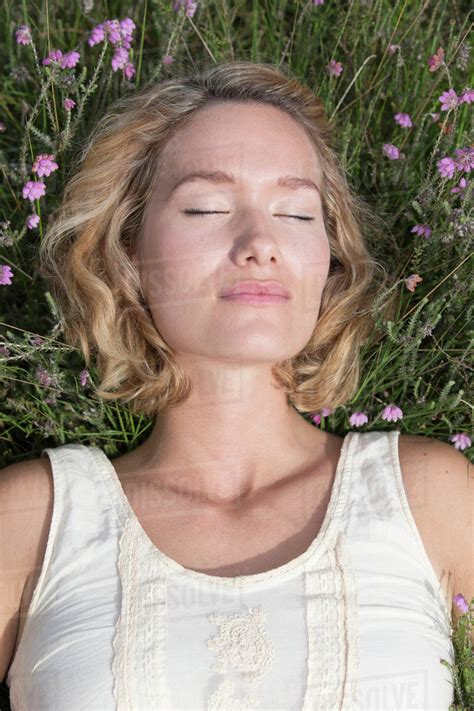 Woman Relaxing On Meadow Stock Photo Dissolve