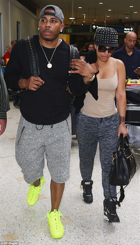 Nelly Keeps His Muscular Arm Around Girlfriend Shantel Jackson As He Jets Into Sydney Daily