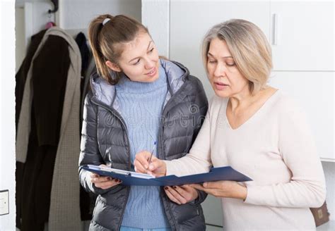Mature Woman Answers Questions Of The Interviewer At Home Stock Photo