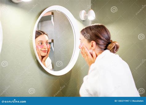 Woman Looking Into The Mirror In The Bathroom Stock Image Image Of Reflection White 130371997