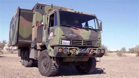Military Truck With Extending Sides Becomes Camper With Solar Roof